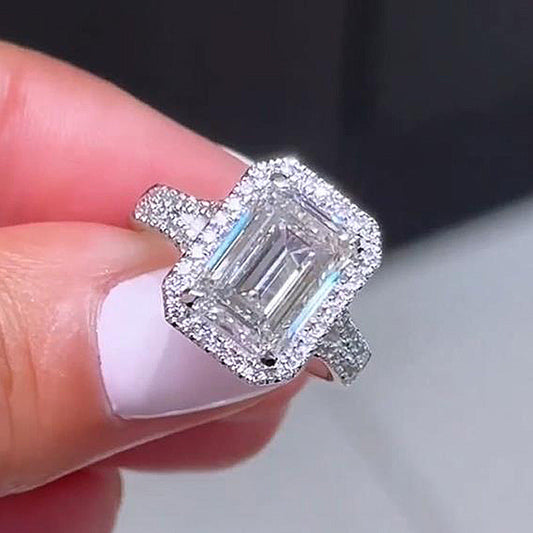 Luxury Halo Split Shank Emerald Cut Engagement Ring In Sterling Silver