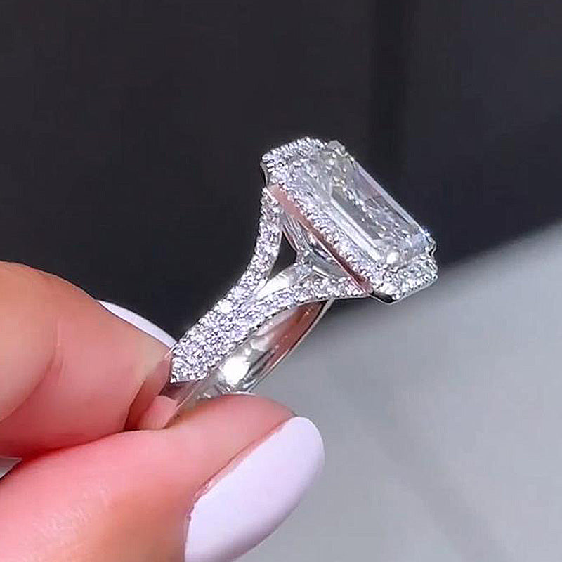 Luxury Halo Split Shank Emerald Cut Engagement Ring In Sterling Silver